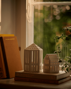 โคมเทียนเซรามิก Kähler Urbania รูปบ้านสีขาว ช่องหน้าต่างเจาะมือ ให้แสงอบอุ่นผ่านช่องหน้าต่าง เติมบรรยากาศอบอุ่นในบ้าน งานออกแบบเดนมาร์กสไตล์มินิมอล จัดจำหน่ายโดย Old Pine Trees